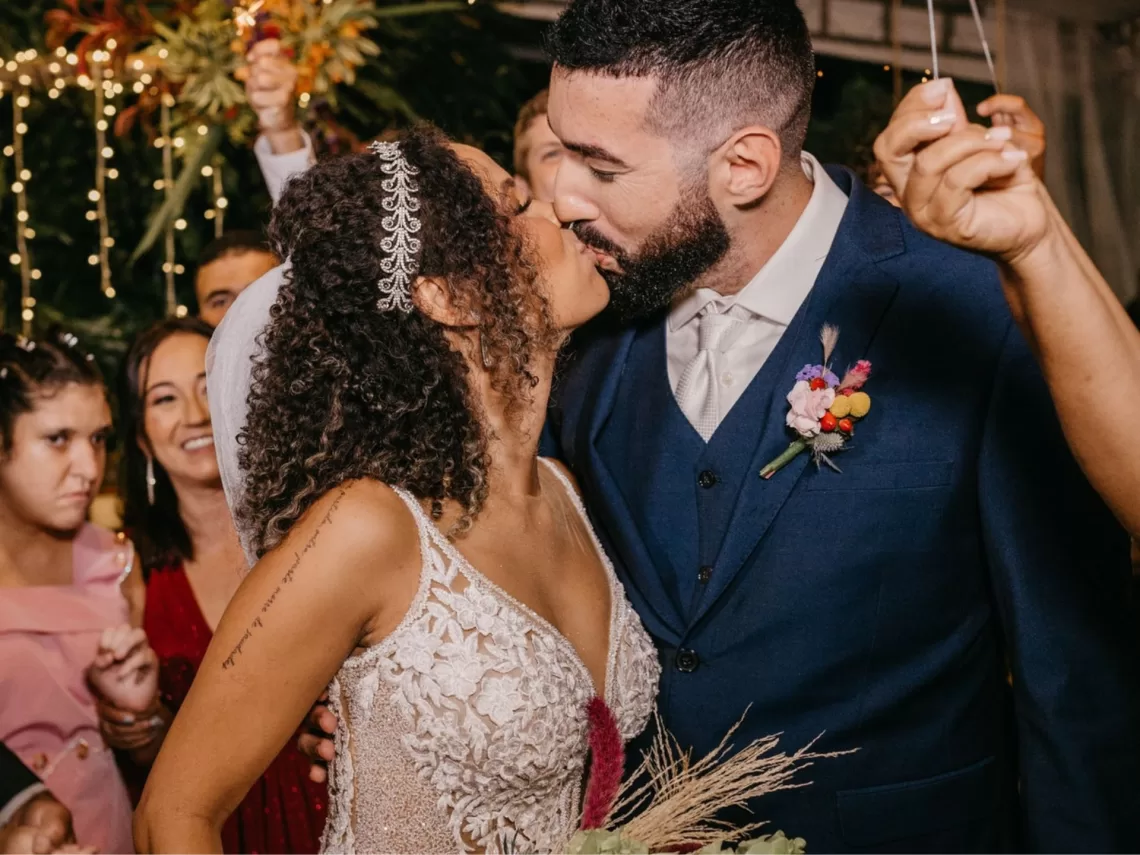 A bride and groom kissing at their wedding.