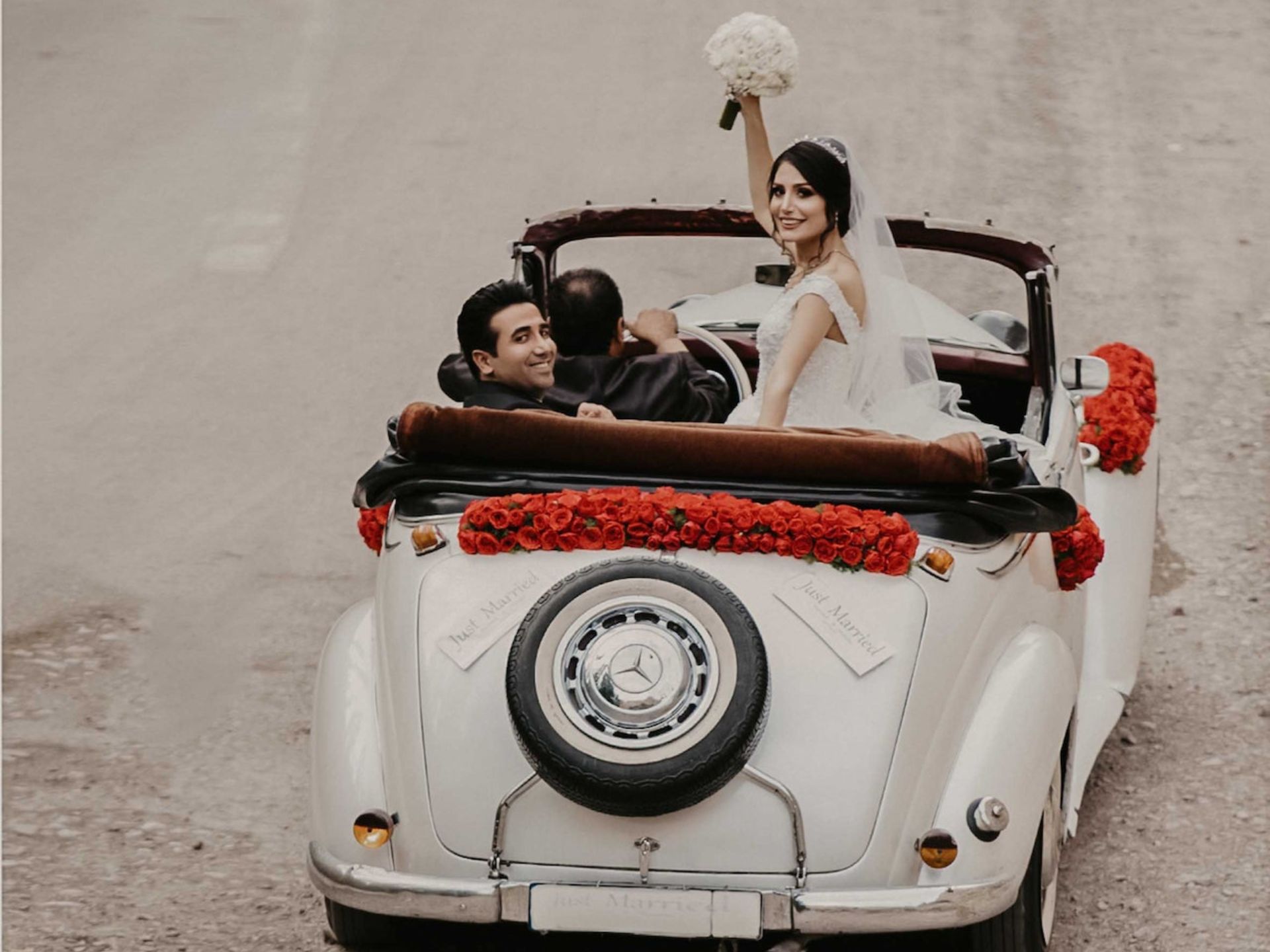 A bride and groom leaving their wedding.