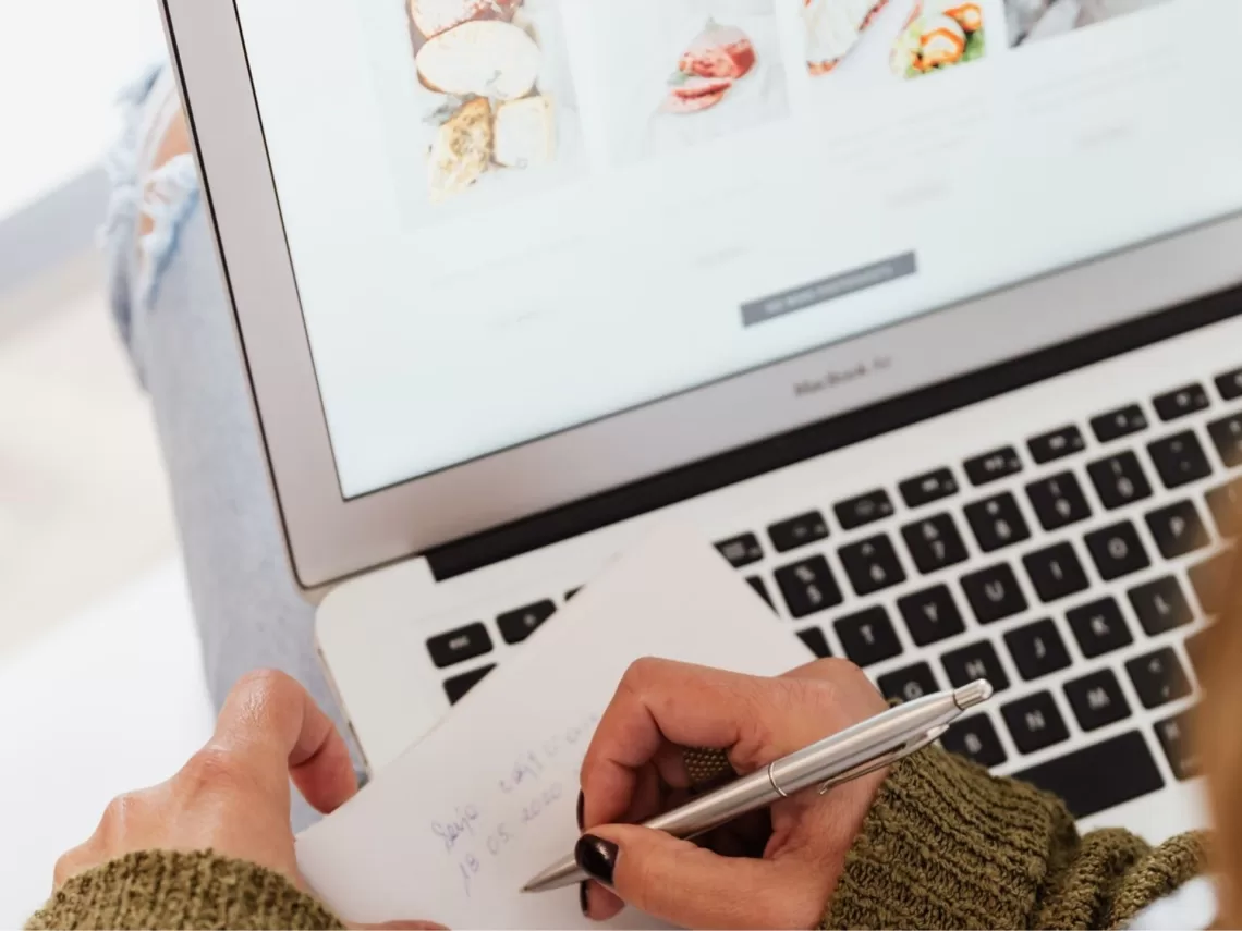 A bride writing notes from her laptop.