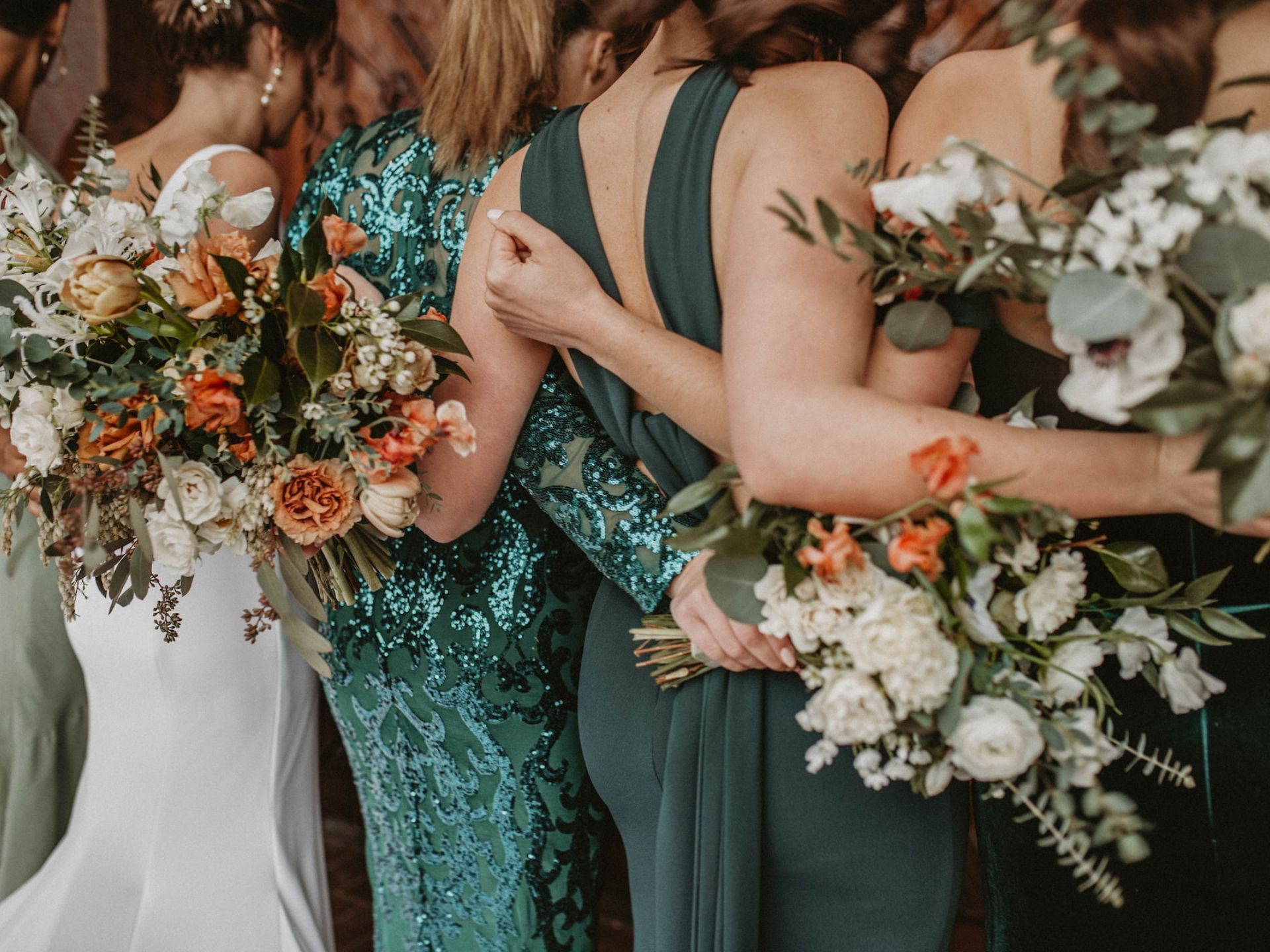 Bridesmaids wearing green dresses.