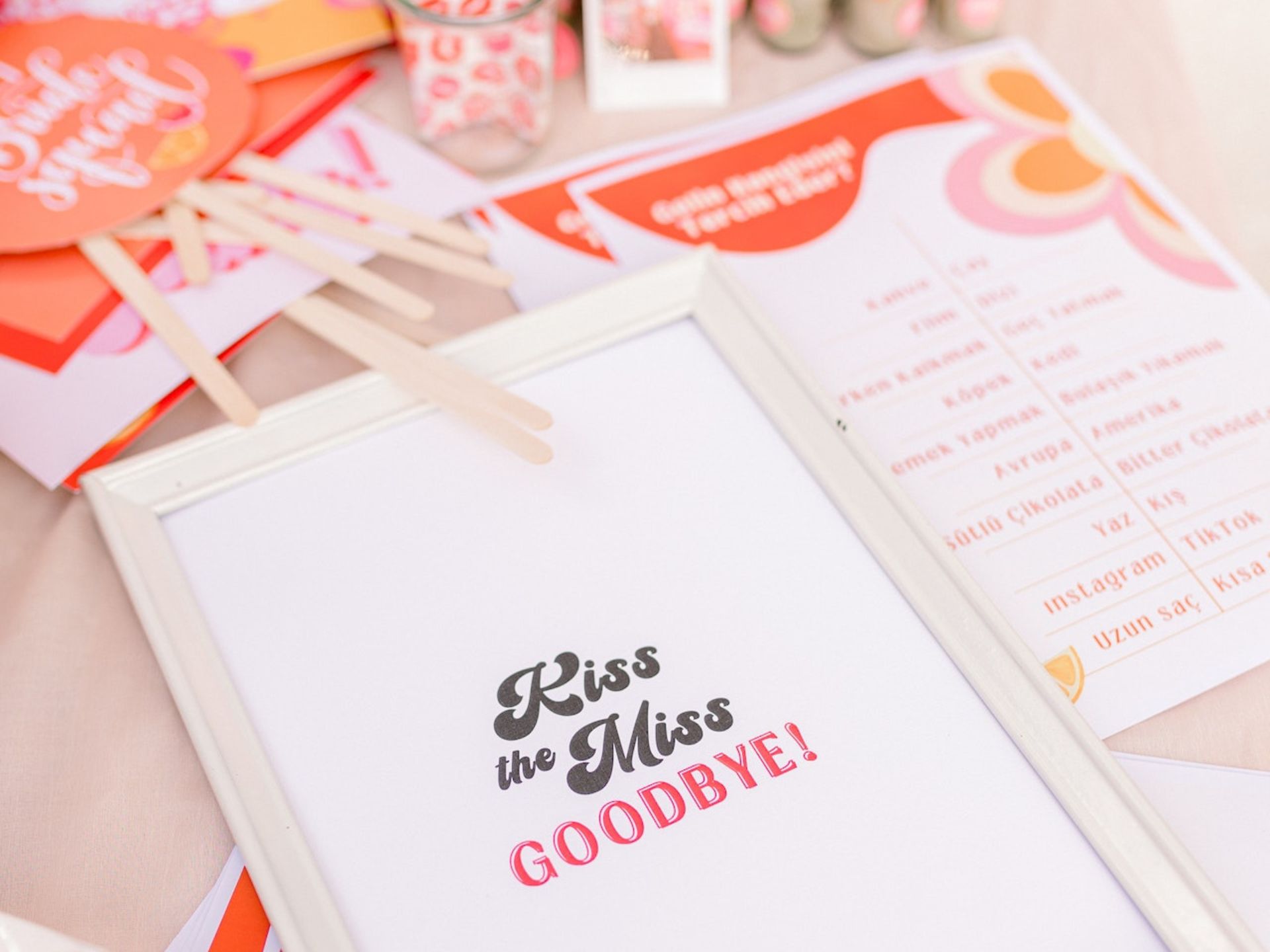 A table with photo booth props for a bridal shower.