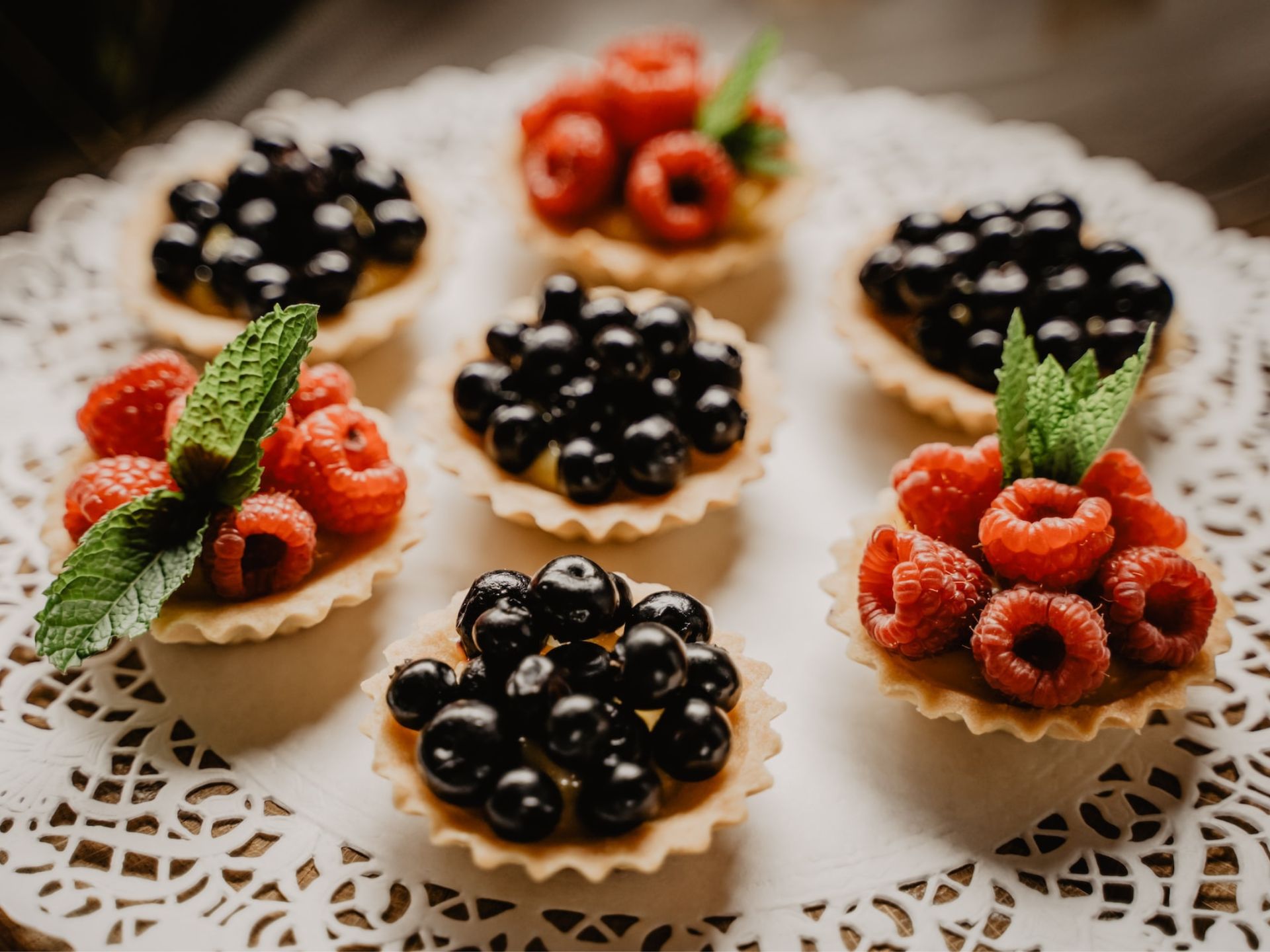A platter of mini berry pies.