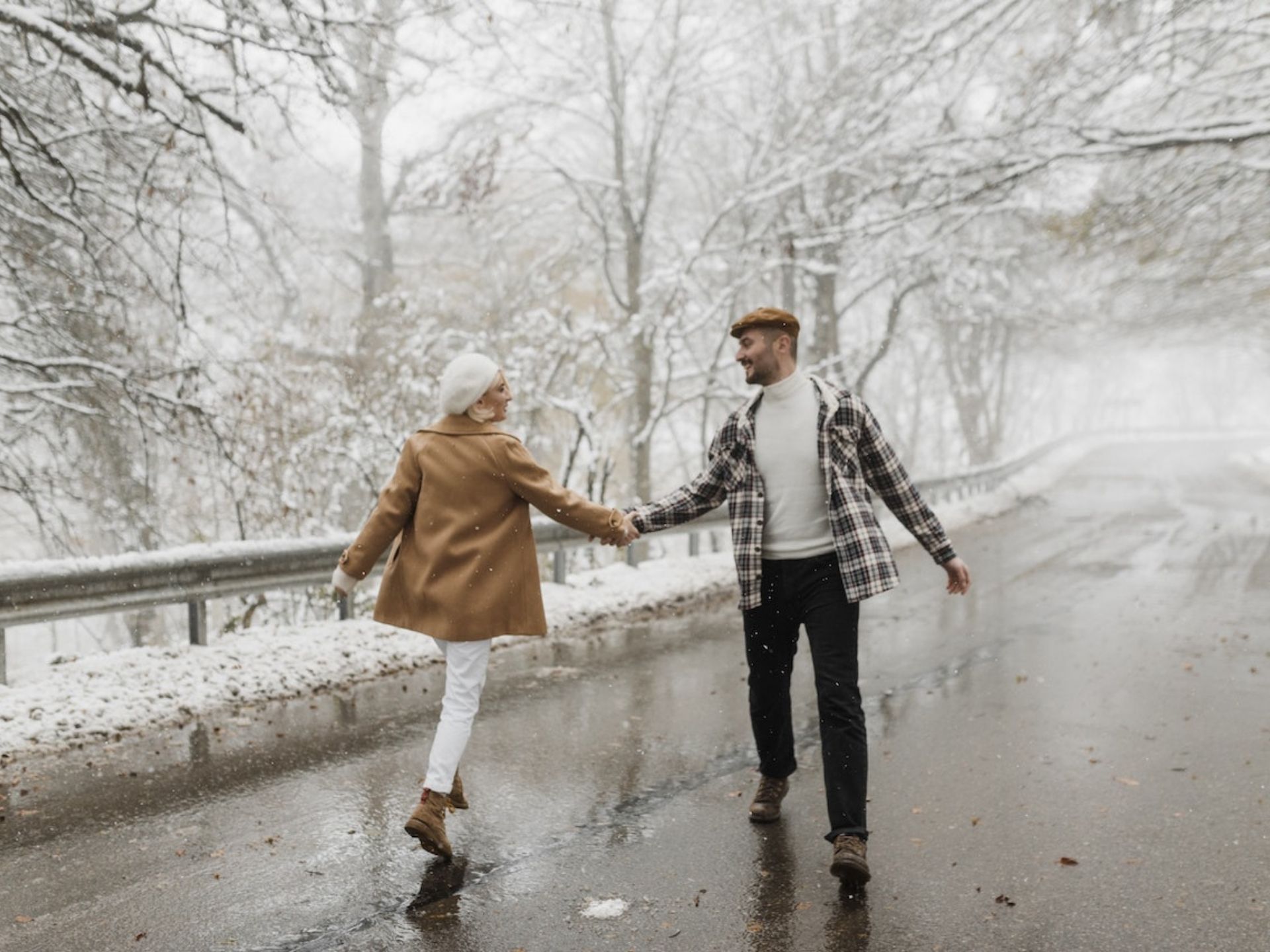 A couple walking in the snow.