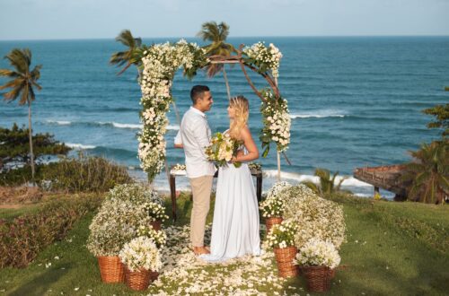 A bride and groom eloping on a beach.