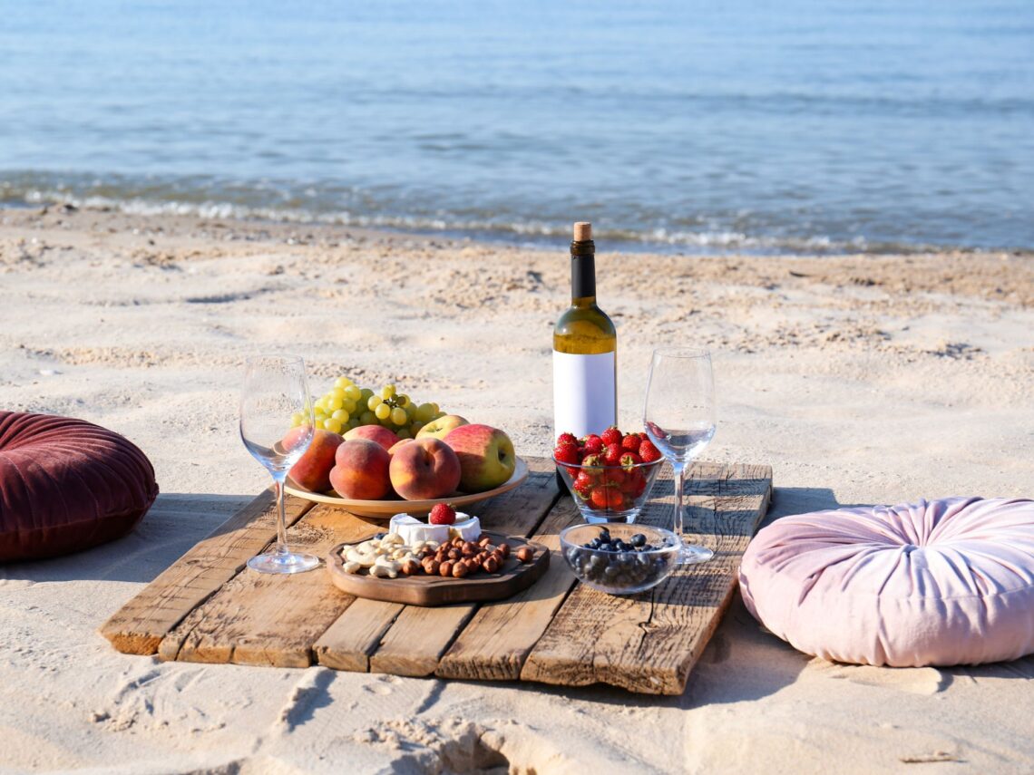 A couple having a picnic on the beach.