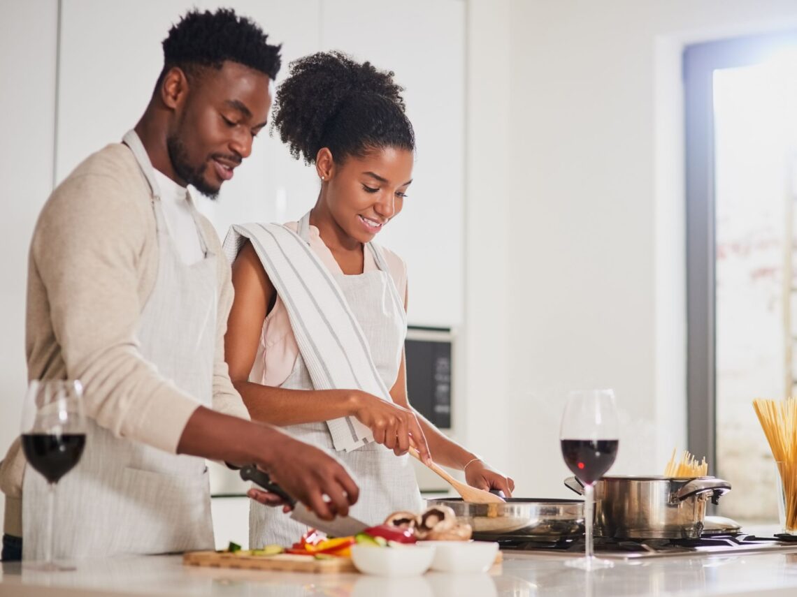 A man and women cooking together.