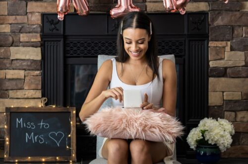 A bride to be opening presents at her bridal shower.
