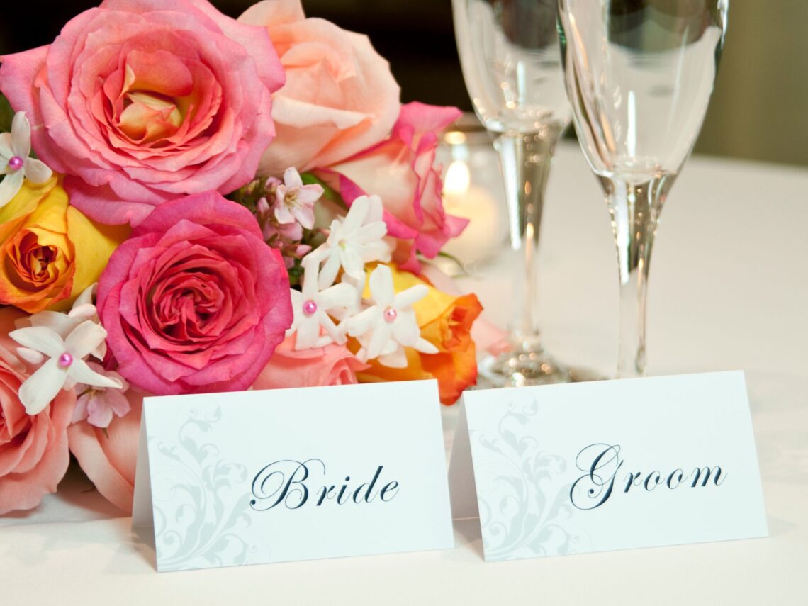 A wedding table with bride and groom place cards.