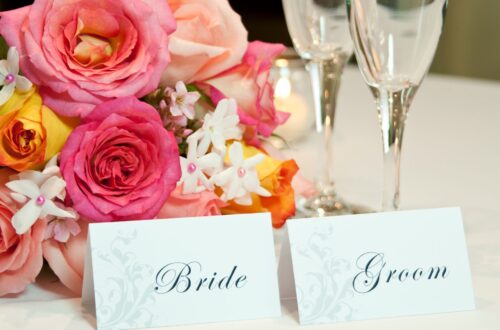 A wedding table with bride and groom place cards.