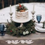 A winter wedding cake on a wooden table.