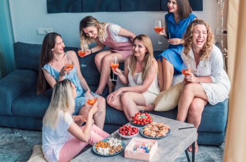 A group of girls at a bachelorette party with food and wine.