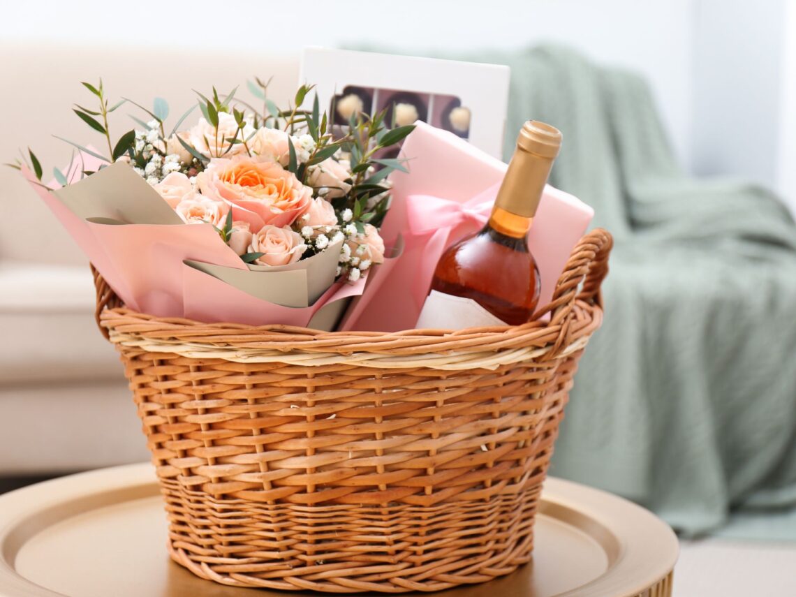 A wedding gift basket filled with champagne and flowers.