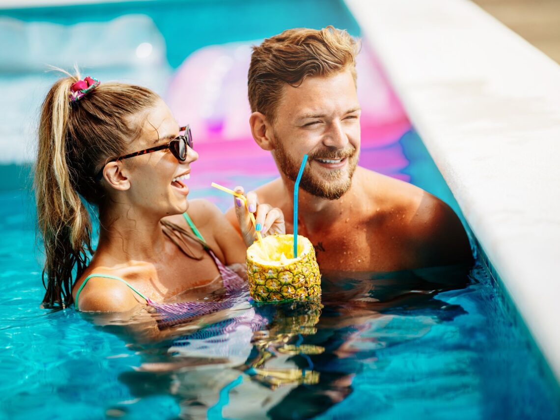 A couple swimming in a pool.