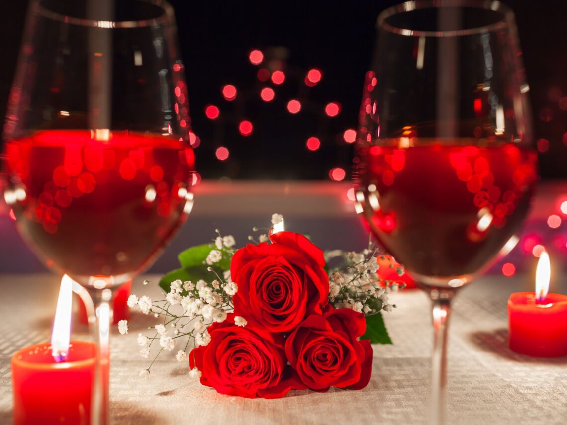 A table with red wine and text fun date ideas for year round.