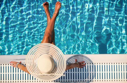 A photo of a girl tanning at the pool.