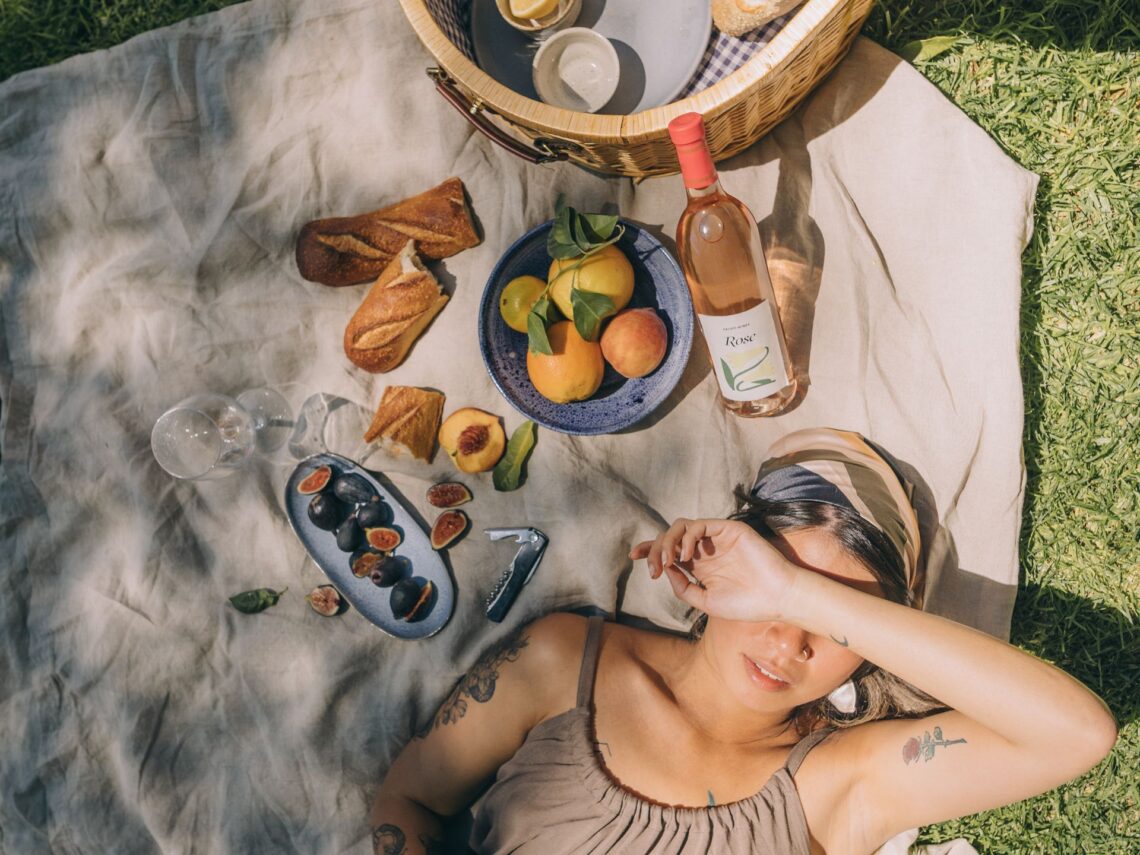 A girl having a picnic in her backyard.