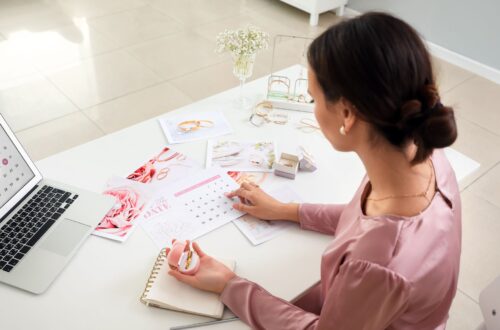 A woman sitting at a white desk planning her wedding.