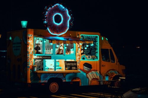 A photo of a donut food truck at night.