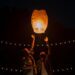 A couple releasing a lantern into the sky.