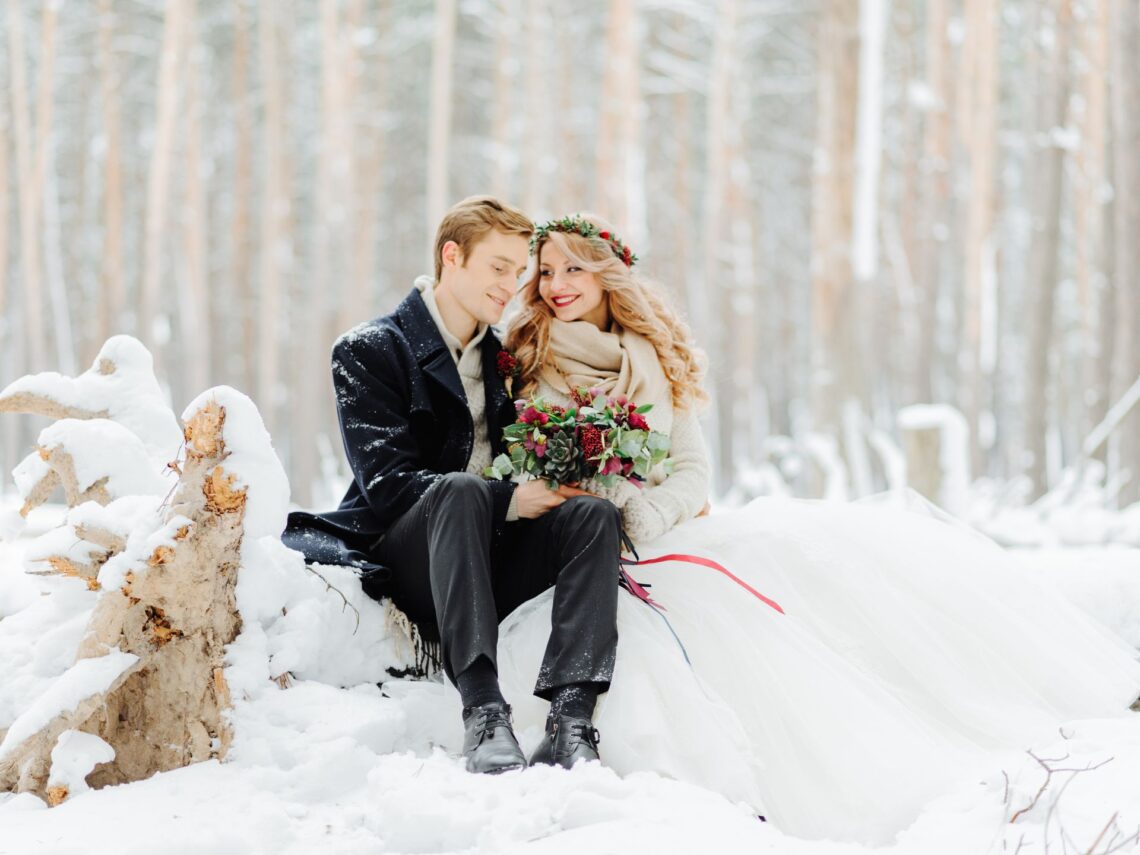 A couple getting married outside in the snow.