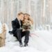 A couple getting married outside in the snow.