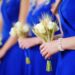 A group of bridesmaids wearing royal blue colored dresses.