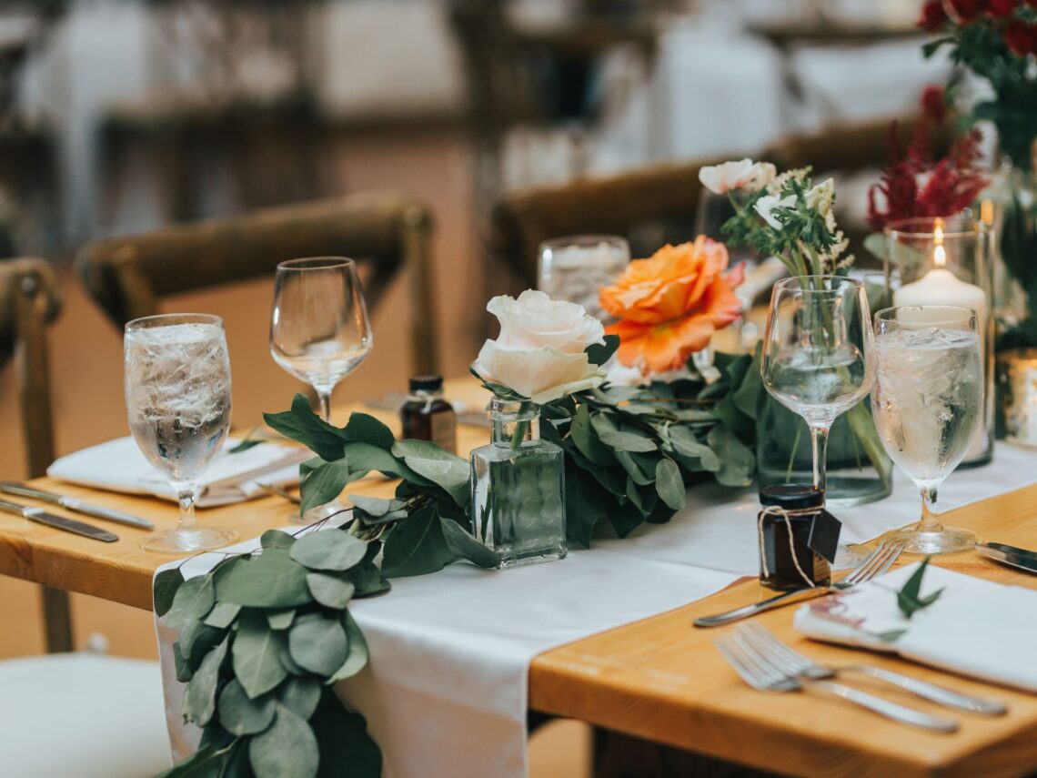 A wedding table with fall themed flowers on top.