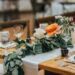 A wedding table with fall themed flowers on top.