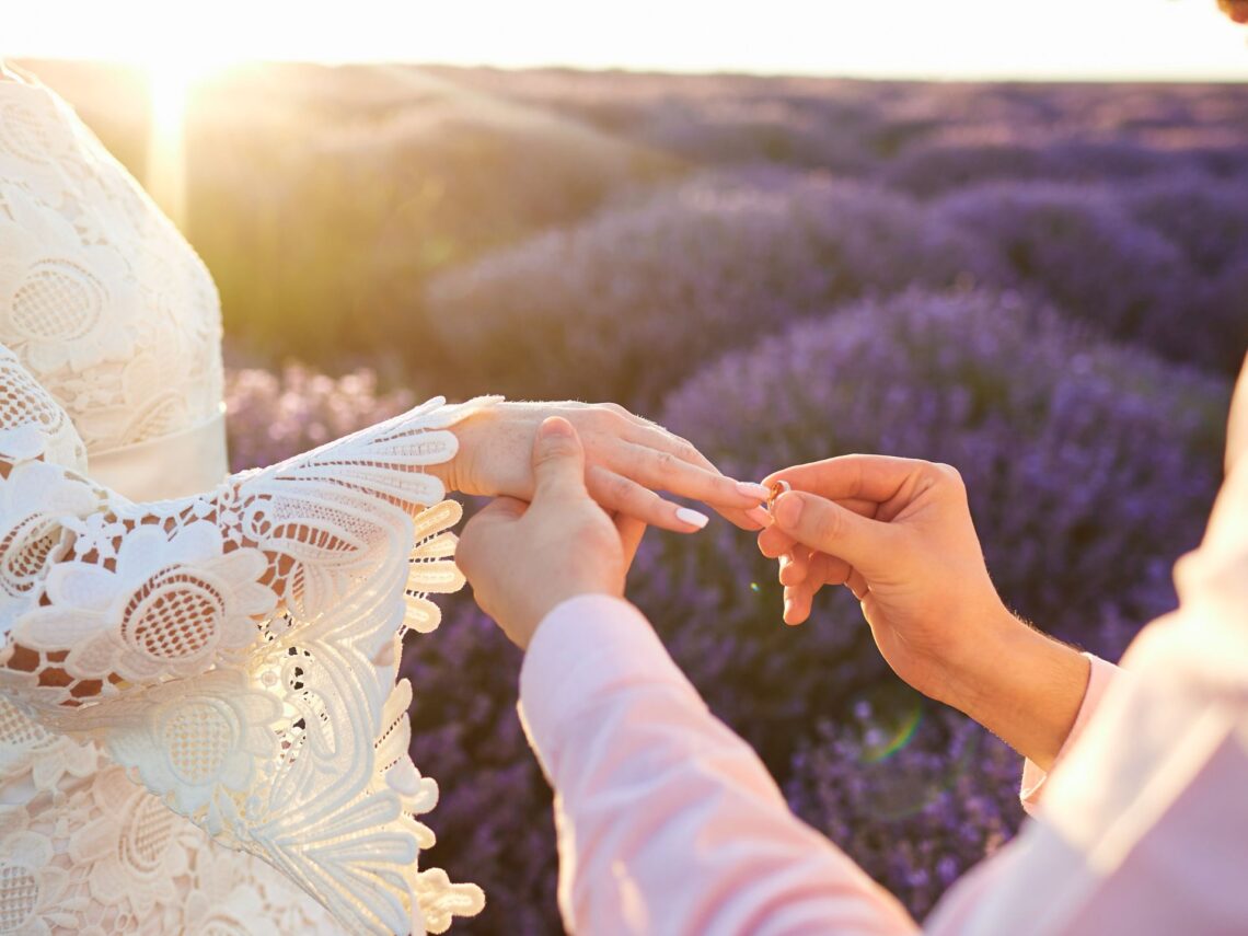 A bride and groom surrounded by a lavender field.