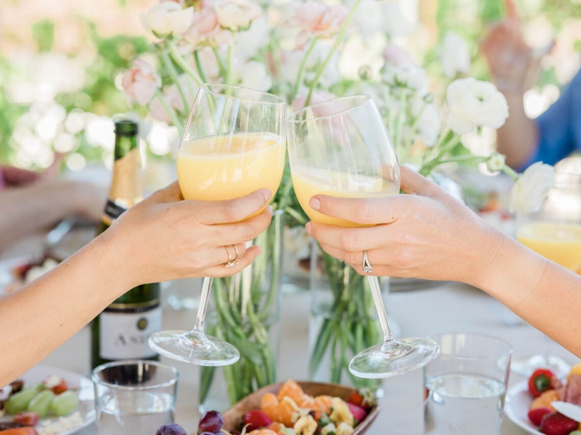 Bridesmaids drinking mimosas at a brunch party.