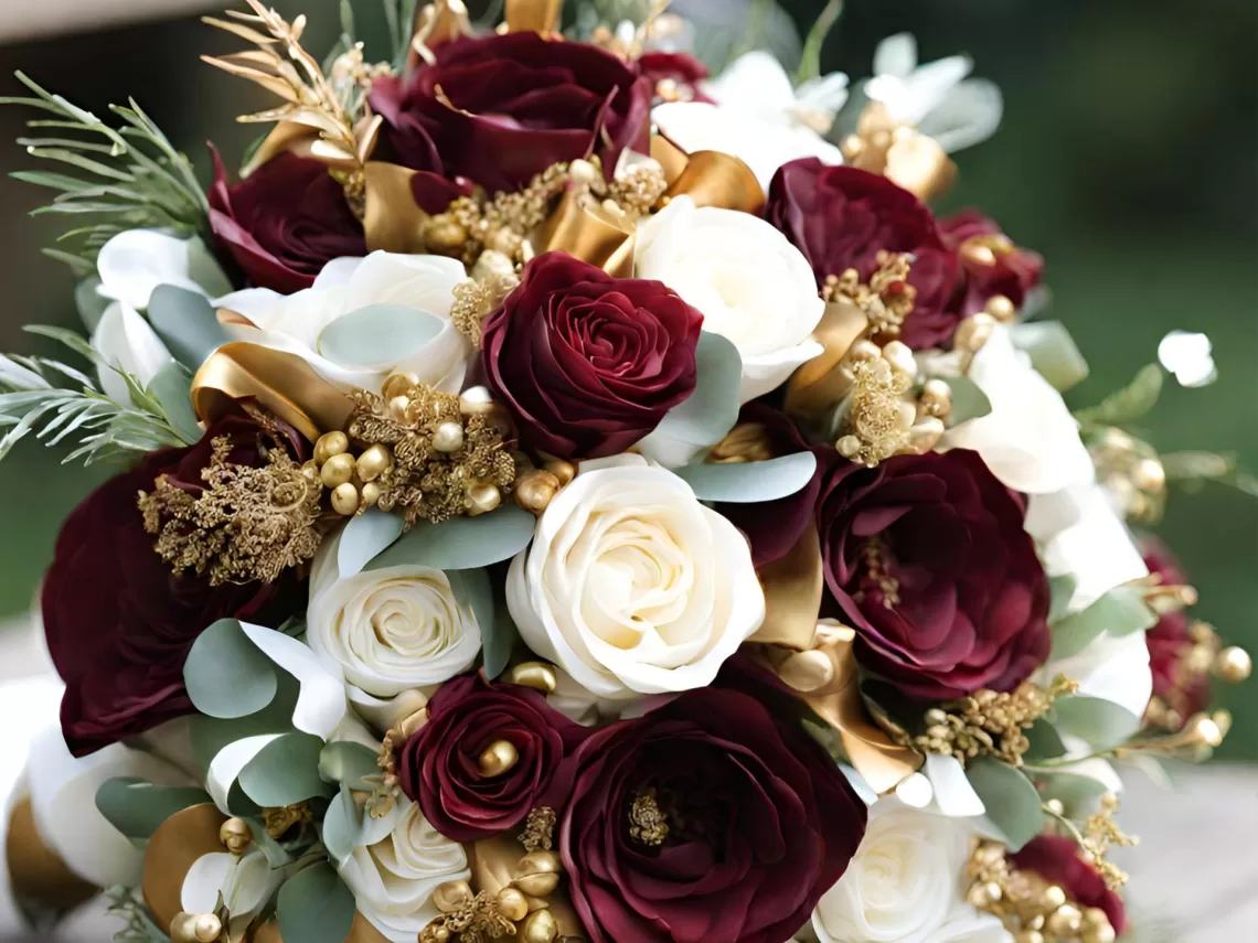 A wine red and gold wedding bouquet.