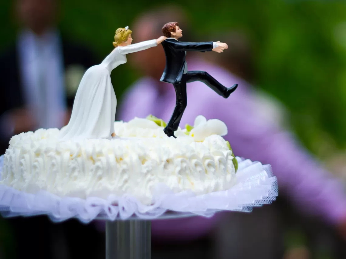 A funny bride and groom cake topper.