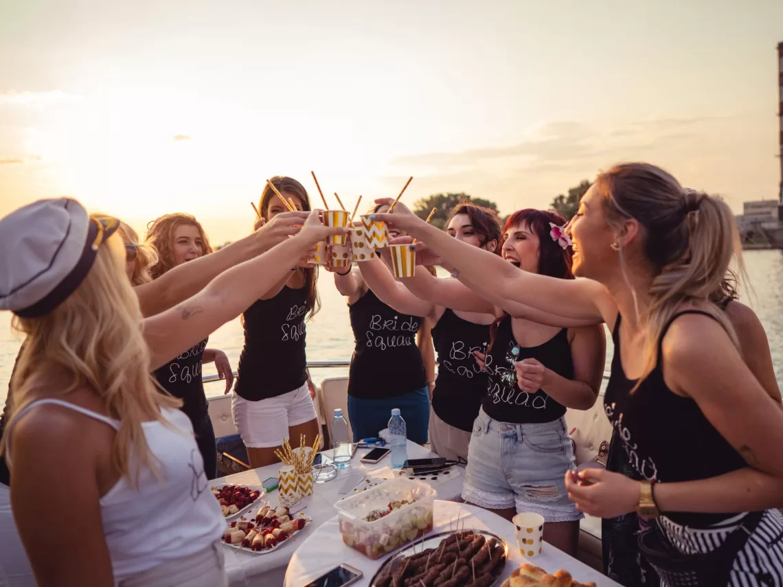 A bachelorette party on a sunset cruise with the text best spring bachelorette party ideas.