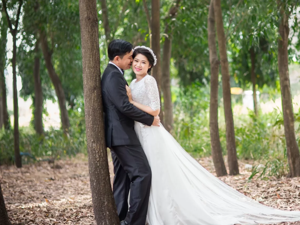 An asian couple having a wedding in the forest.